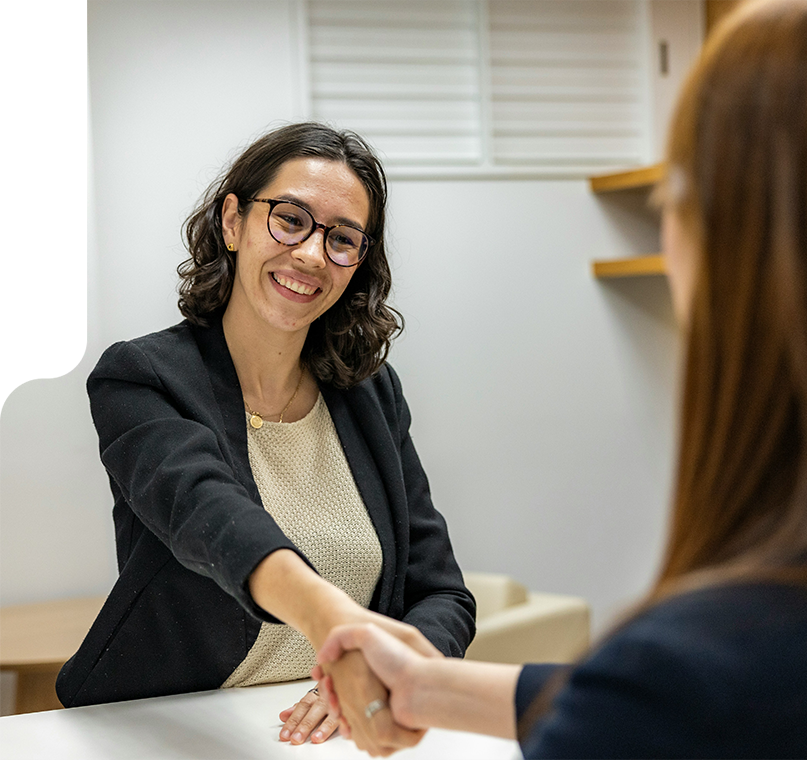 two women shaking hands