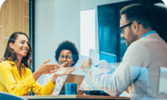 coworkers smiling and talking in office meeting